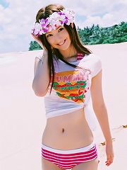 Long haired asian cutie having fun in a striped hot pink bikini